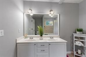 full bathroom with double vanity and a shower with curtain