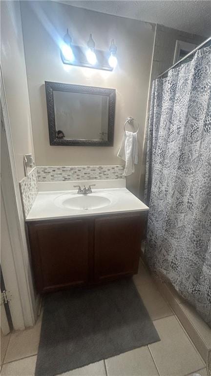 bathroom with vanity, tile patterned flooring, a textured ceiling, and a shower with shower curtain