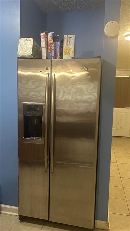 kitchen view of stainless steel fridge and baseboards