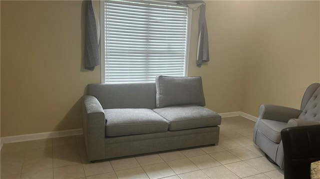 living area with baseboards and light tile patterned flooring