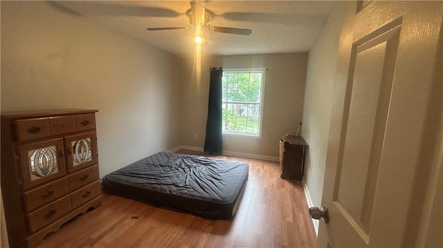 bedroom with light wood-style flooring and ceiling fan
