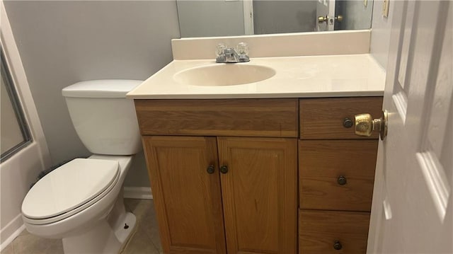 bathroom with vanity, toilet, and tile patterned flooring