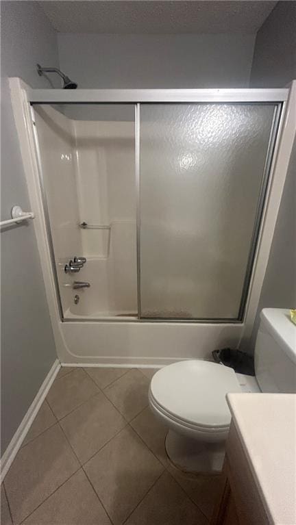 full bath with tile patterned floors, toilet, combined bath / shower with glass door, and vanity