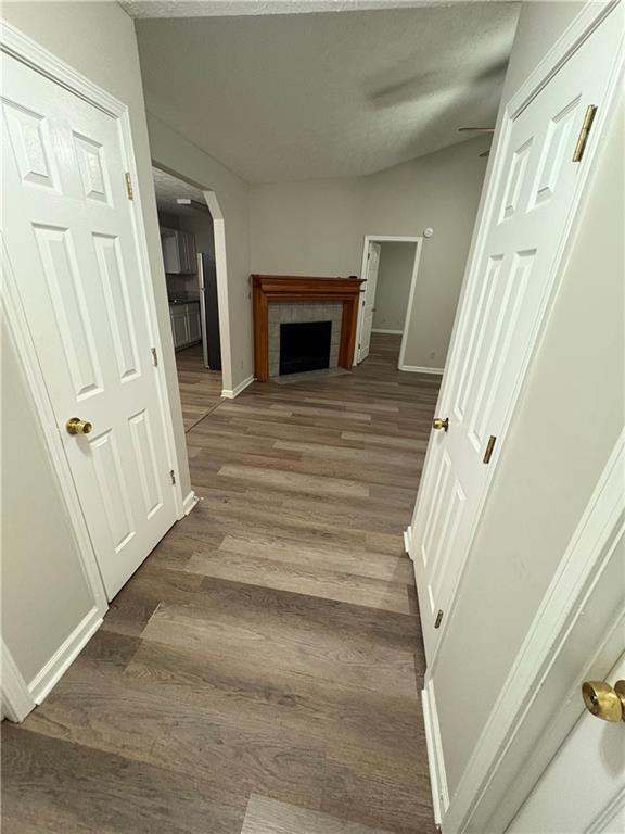 9161 Fairway Ct, Riverdale, GA 30274 - hall with wood finished floors, baseboards, and arched walkways