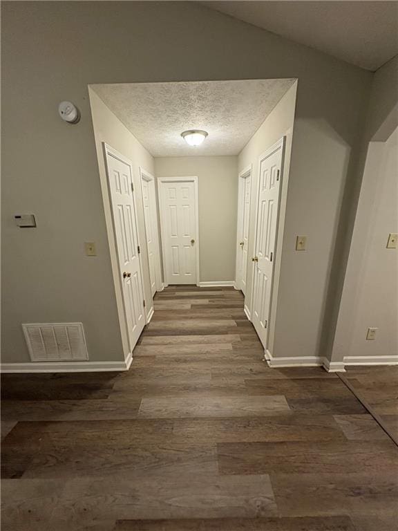 9161 Fairway Ct, Riverdale, GA 30274 - hallway with baseboards, visible vents, wood finished floors, and a textured ceiling
