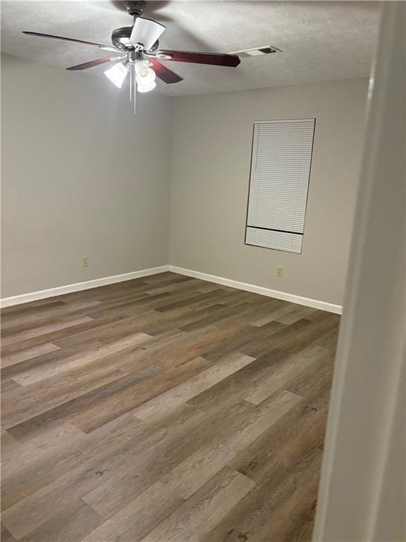 9161 Fairway Ct, Riverdale, GA 30274 - spare room featuring baseboards, ceiling fan, a textured ceiling, and dark wood-type flooring