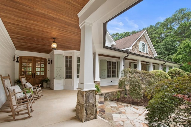 exterior space with french doors and a porch