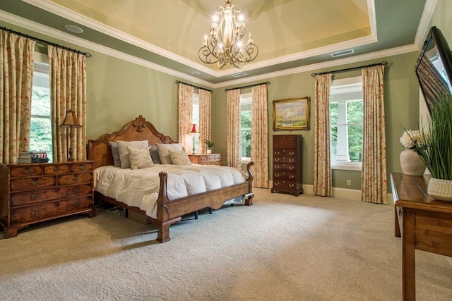 carpeted bedroom featuring ornamental molding, a raised ceiling, and a chandelier