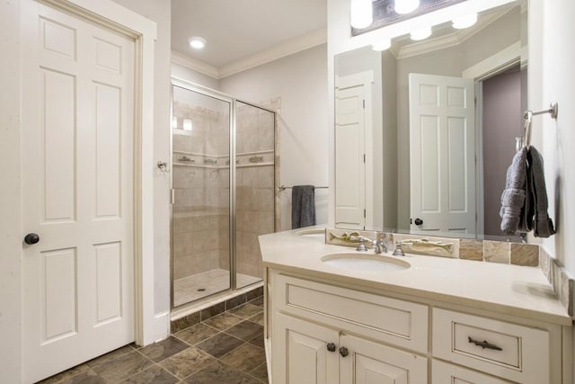 bathroom featuring walk in shower, ornamental molding, and vanity