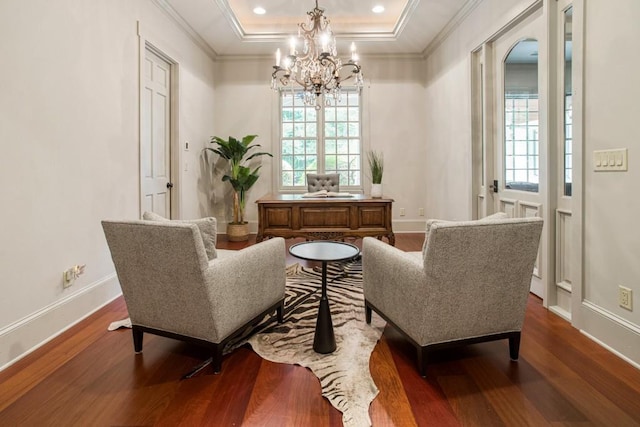 living area with ornamental molding, dark hardwood / wood-style flooring, and a tray ceiling