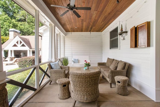 sunroom / solarium with wooden ceiling and ceiling fan