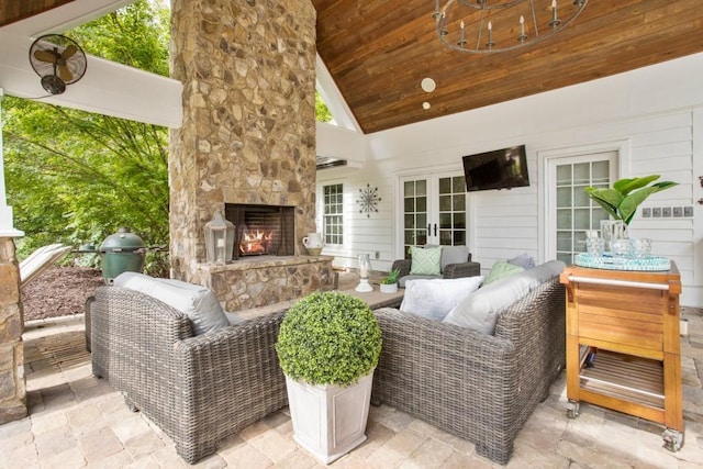 view of patio with a grill, french doors, and an outdoor stone fireplace