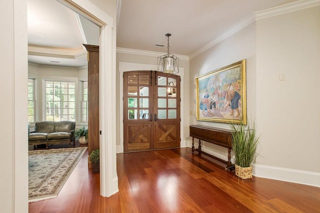 entrance foyer featuring ornamental molding, dark hardwood / wood-style flooring, and french doors