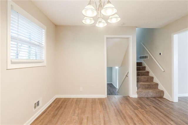 4412 Rustic Wood Dr, Stone Mountain, GA 30083 - unfurnished room featuring hardwood / wood-style floors and an inviting chandelier