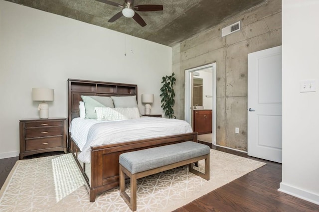 bedroom featuring visible vents, connected bathroom, baseboards, wood finished floors, and a ceiling fan