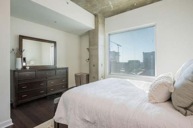 bedroom with dark wood-style floors and baseboards