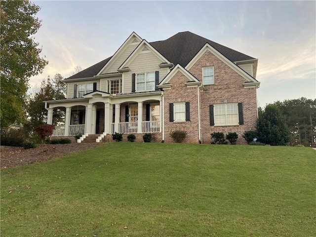 craftsman-style home featuring a lawn and covered porch