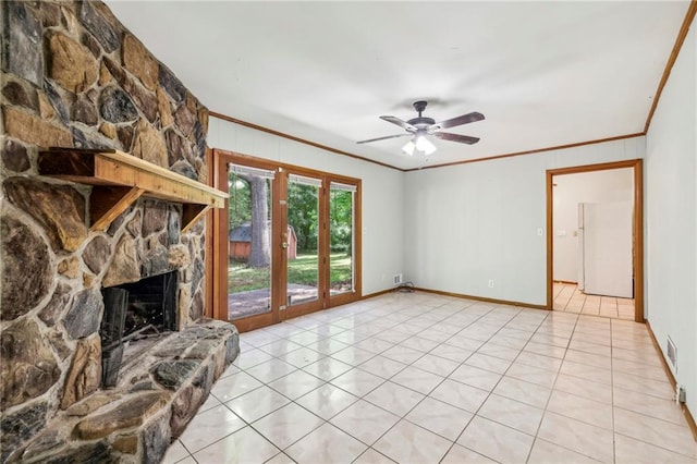 unfurnished living room with ornamental molding, a fireplace, ceiling fan, light tile patterned floors, and baseboards
