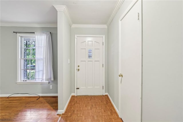 foyer entrance with crown molding, baseboards, and parquet floors