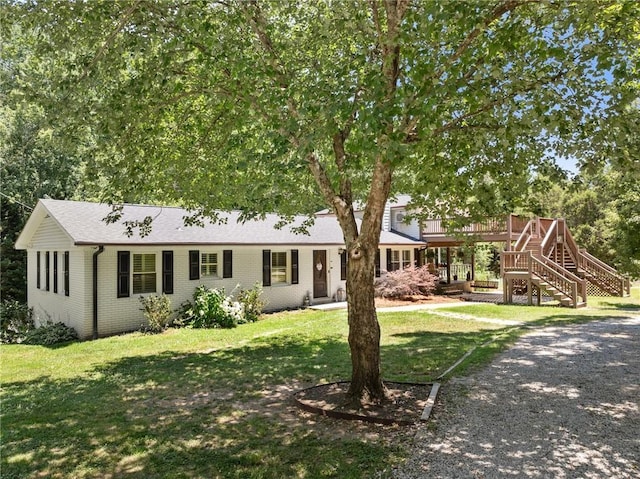 ranch-style house with a front lawn and a deck