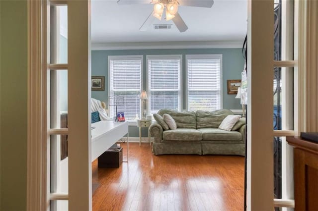 interior space featuring crown molding, ceiling fan, and hardwood / wood-style floors