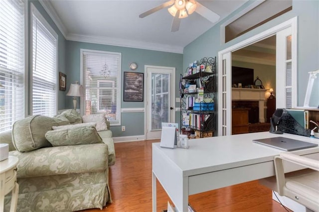 interior space featuring ornamental molding, hardwood / wood-style flooring, and ceiling fan