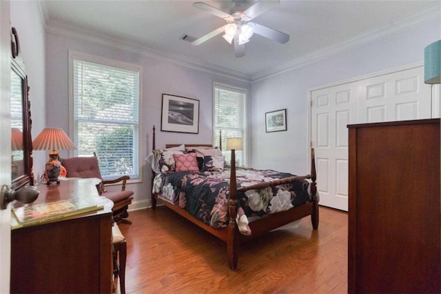 bedroom featuring wood-type flooring, ornamental molding, and ceiling fan