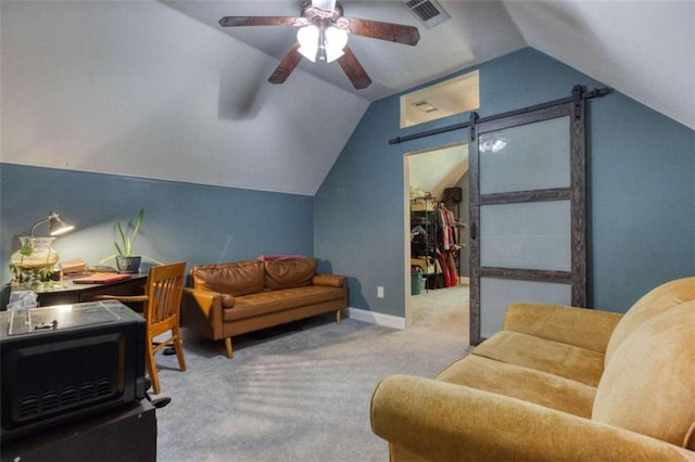 living room featuring a barn door, ceiling fan, carpet, and vaulted ceiling