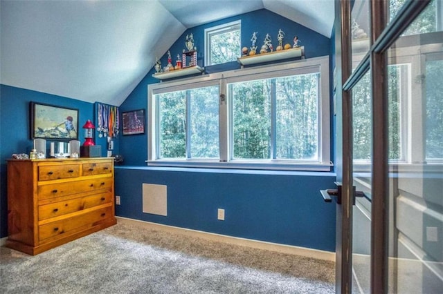 carpeted bedroom featuring vaulted ceiling and multiple windows