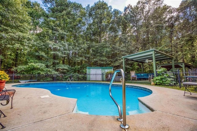 view of swimming pool featuring a diving board and a patio area