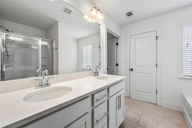 bathroom featuring double vanity, visible vents, and a sink