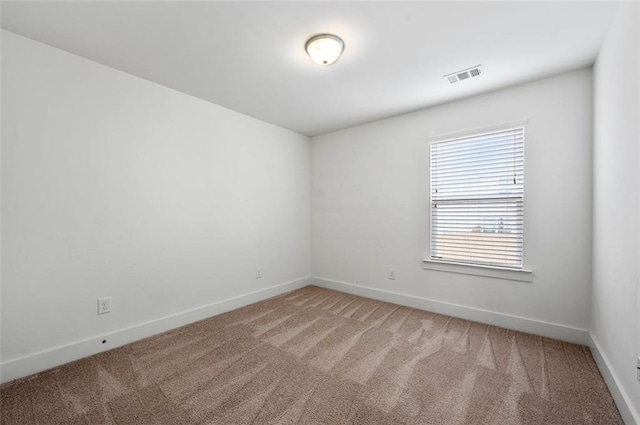 unfurnished room with baseboards, visible vents, and carpet flooring
