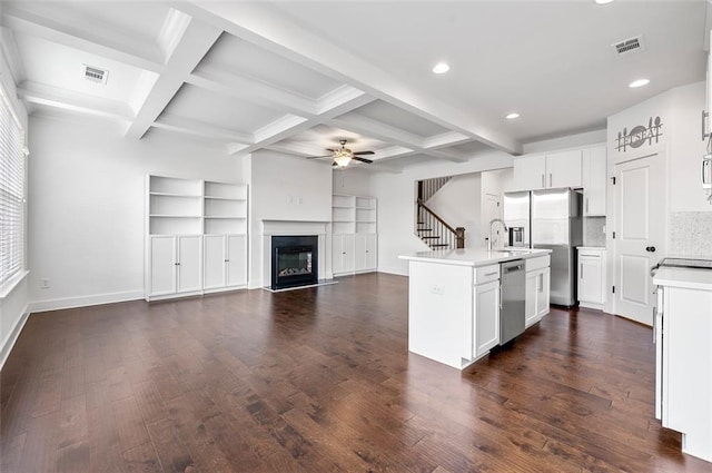 kitchen featuring a center island with sink, visible vents, appliances with stainless steel finishes, open floor plan, and light countertops