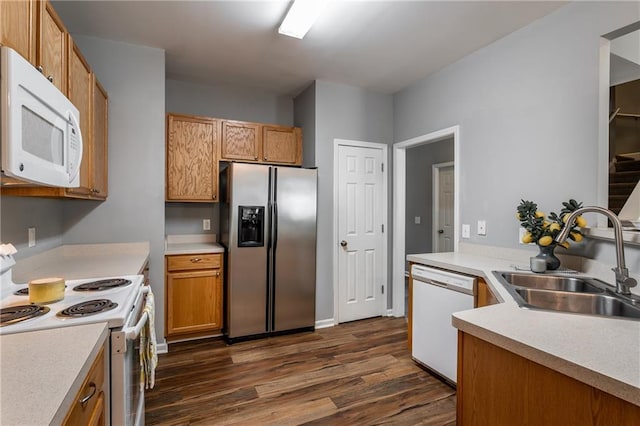 208 Oconee Way, Canton, GA 30114 - kitchen featuring white appliances, a sink, dark wood finished floors, light countertops, and brown cabinetry