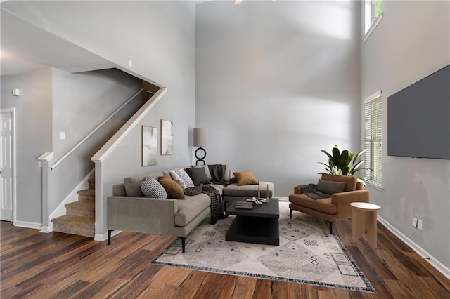208 Oconee Way, Canton, GA 30114 - living area with wood finished floors, stairway, plenty of natural light, and a towering ceiling