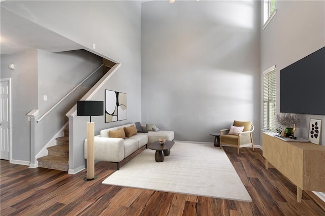 208 Oconee Way, Canton, GA 30114 - living room featuring wood finished floors, stairway, a high ceiling, and baseboards