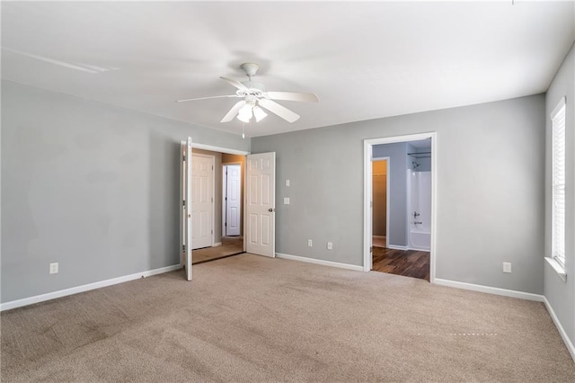 208 Oconee Way, Canton, GA 30114 - unfurnished bedroom featuring carpet, baseboards, a ceiling fan, and connected bathroom