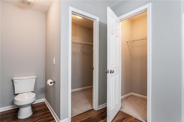 208 Oconee Way, Canton, GA 30114 - bathroom featuring toilet, wood finished floors, a spacious closet, and baseboards