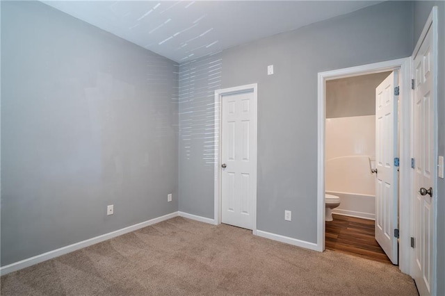 208 Oconee Way, Canton, GA 30114 - unfurnished bedroom with carpet floors, baseboards, and connected bathroom