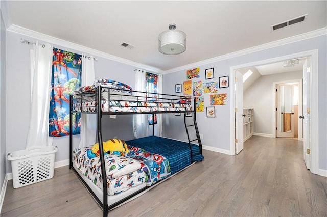 bedroom featuring crown molding and hardwood / wood-style floors