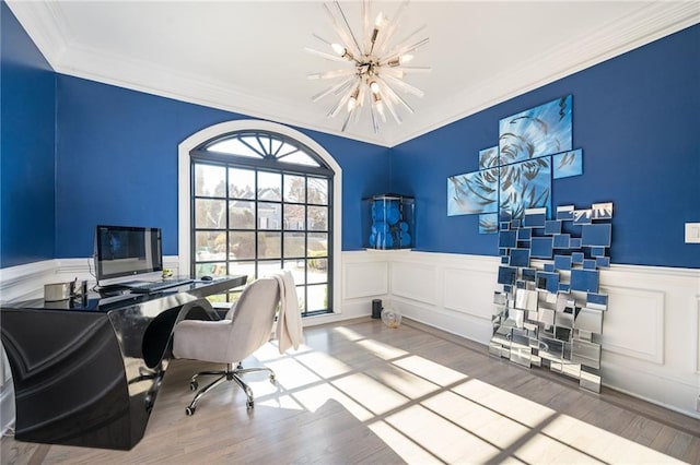 home office featuring light wood-type flooring, ornamental molding, and a chandelier