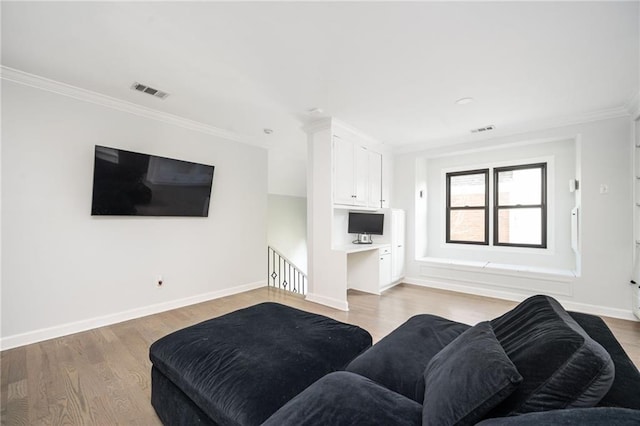 living room featuring ornamental molding and light wood-type flooring