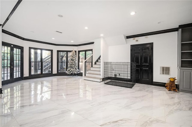 entrance foyer with crown molding and french doors