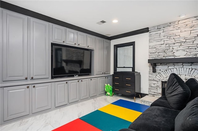 living room with a fireplace and crown molding