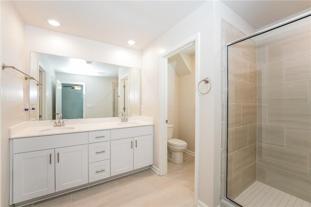 bathroom featuring toilet, walk in shower, tile patterned floors, and vanity