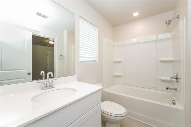 full bathroom featuring toilet, vanity, and  shower combination