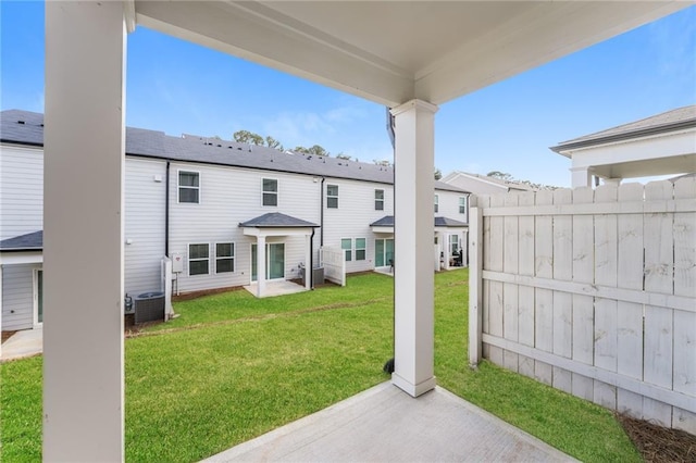 back of property featuring a patio area and a lawn