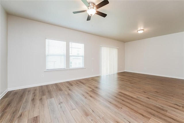 spare room featuring ceiling fan and light wood-type flooring