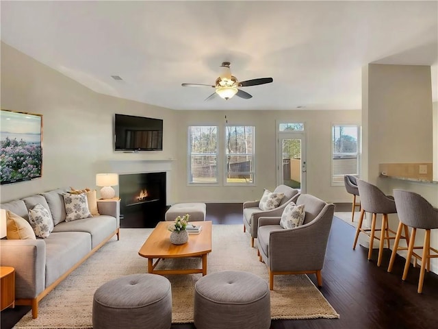 living room featuring hardwood / wood-style floors and ceiling fan