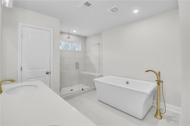 bathroom with plus walk in shower, tile patterned flooring, and sink